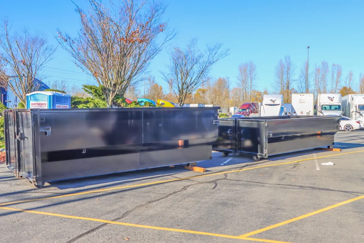 Professional dumpster rental service with roll-off container on residential driveway in Ammon